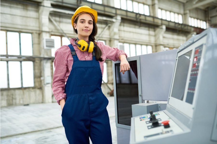 A girl standing beside CNC machine