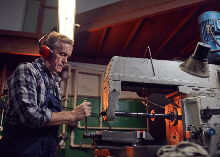 man working in lathe machine